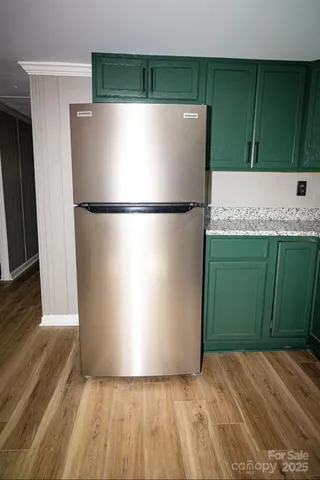 a white refrigerator freezer sitting in a kitchen