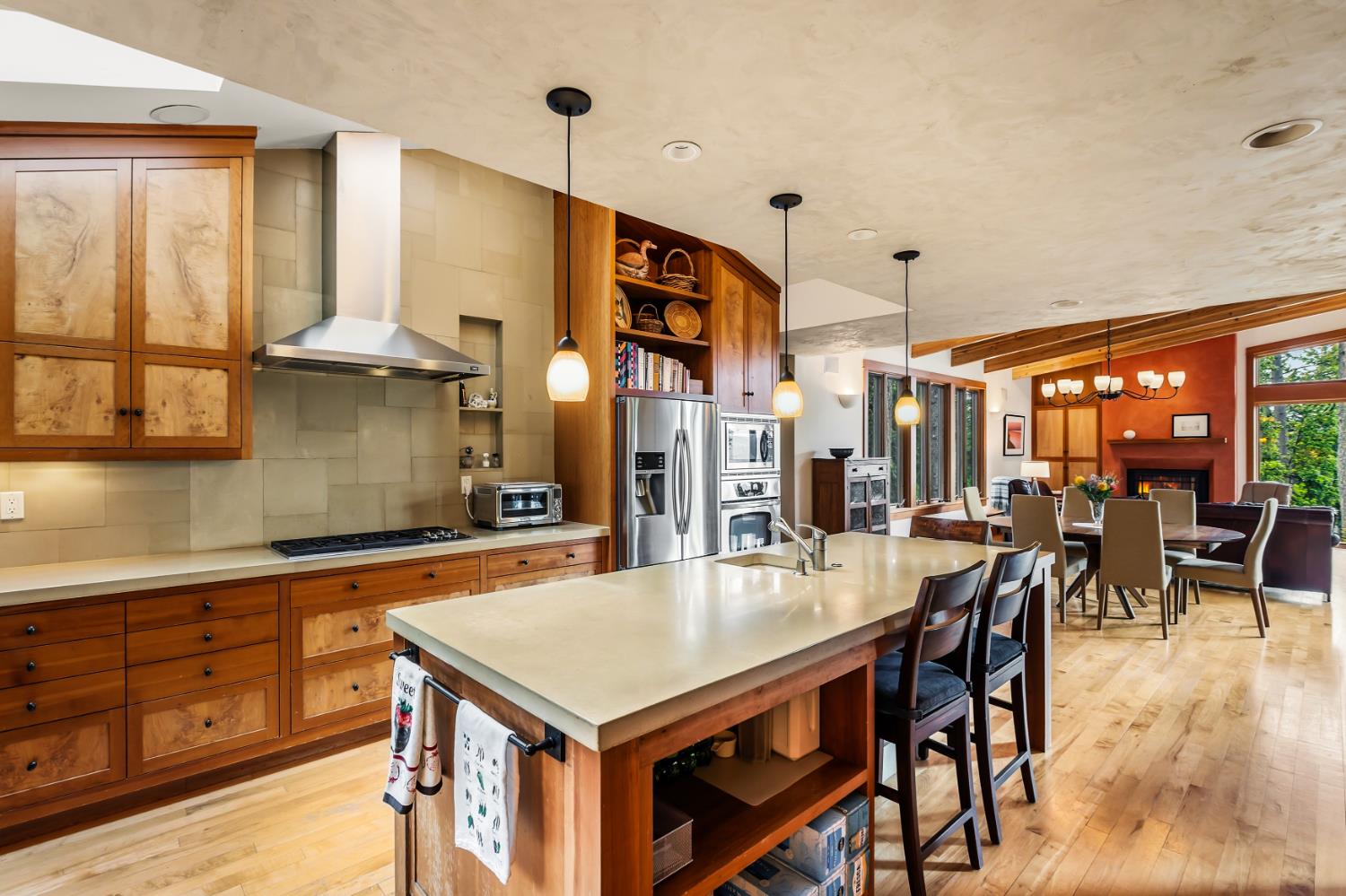 12278 Cement Hill Road Nevada City, CA 95959 - Photo 20 of 61 a kitchen with stainless steel appliances granite countertop a stove a refrigerator a dining table and chairs with wooden floor