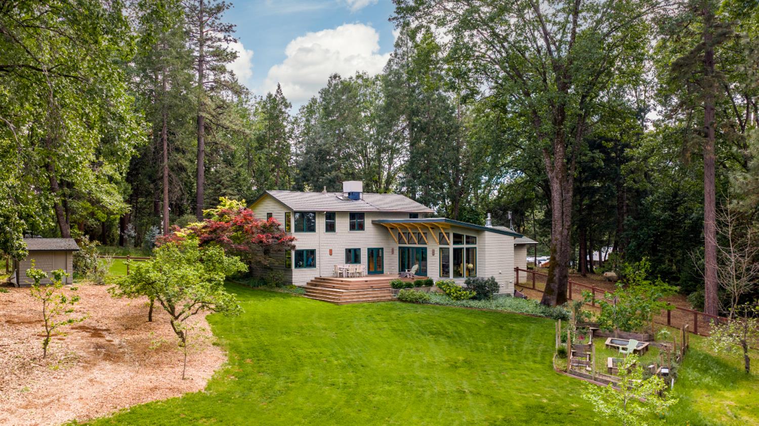 12278 Cement Hill Road Nevada City, CA 95959 - Photo 43 of 61 a view of a house with a yard patio and fire pit