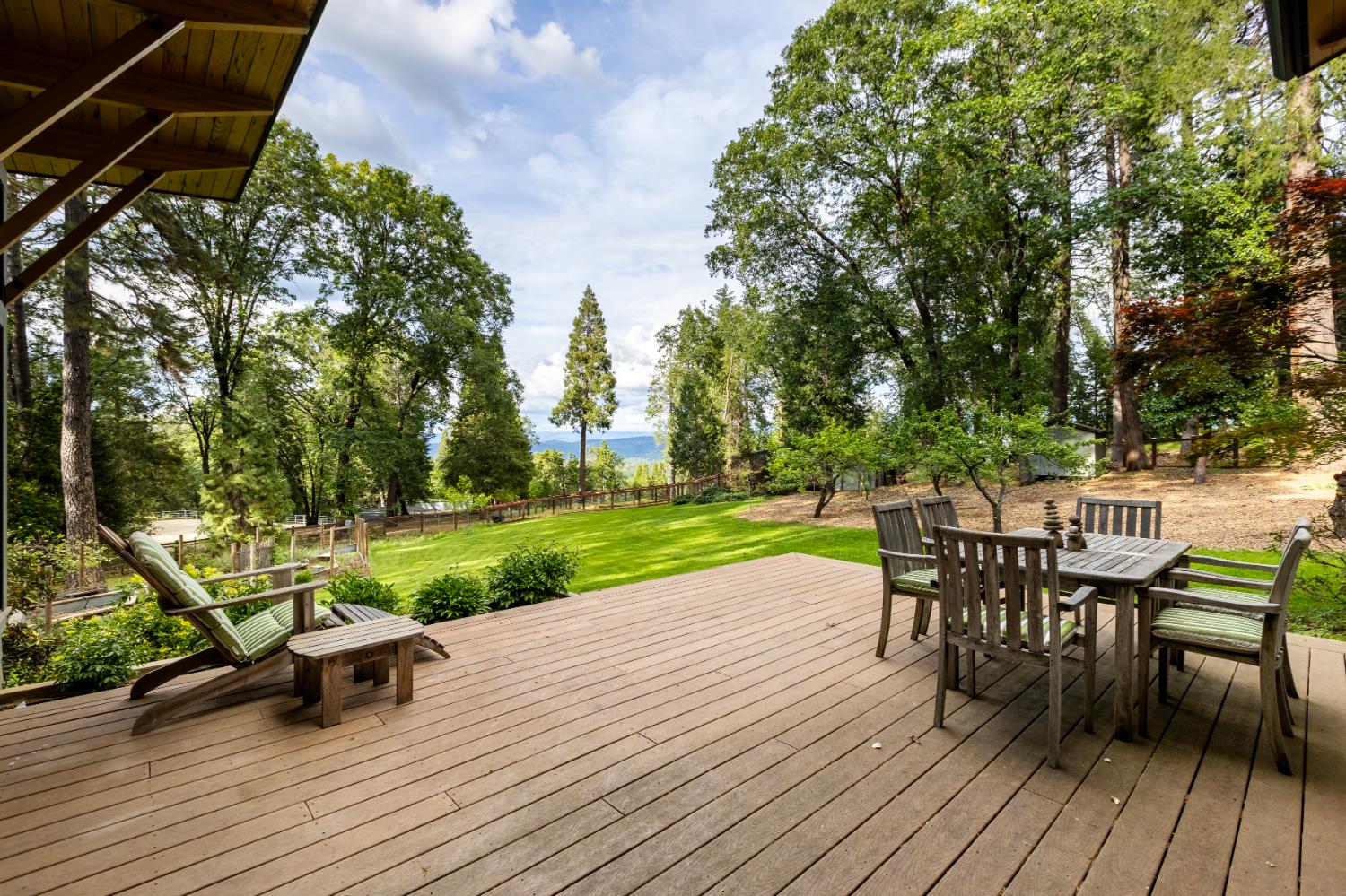 12278 Cement Hill Road Nevada City, CA 95959 - Photo 58 of 61 a view of a deck with table and chairs and wooden floor