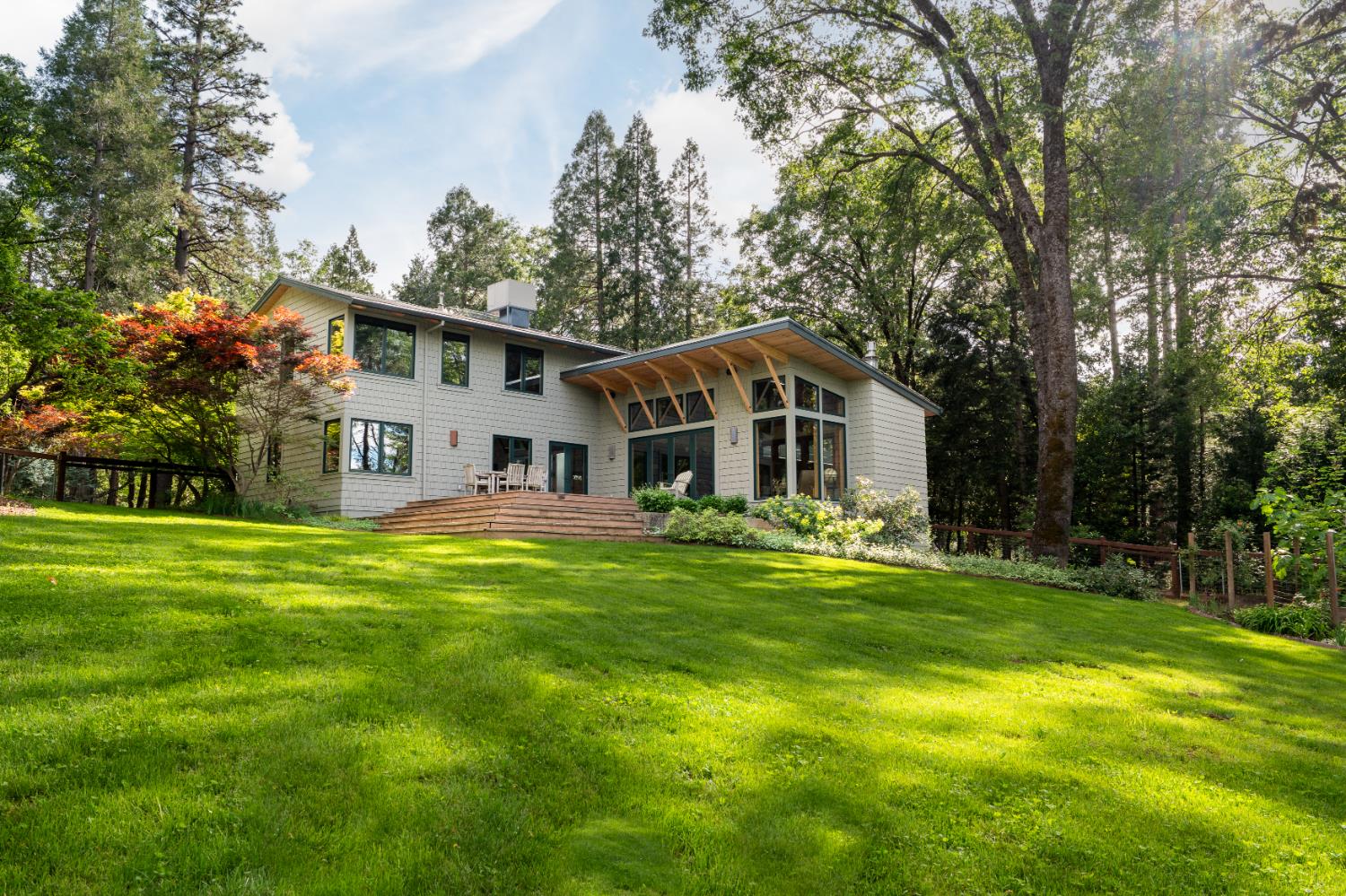 12278 Cement Hill Road Nevada City, CA 95959 - Photo 10 of 61 a front view of a house with a yard table and chairs