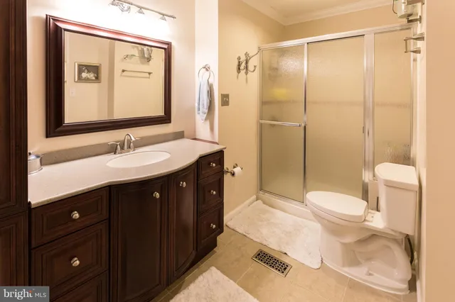 a bathroom with a sink vanity mirror and toilet