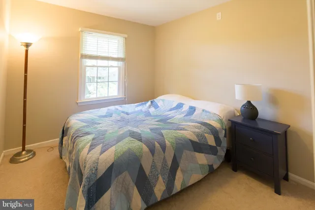 a bed sitting in a bedroom next to a window