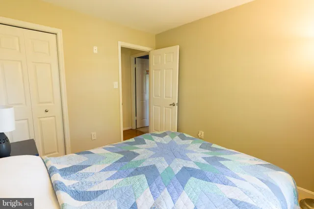 a bedroom with a bed and a mirror