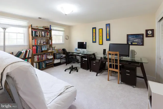 a living room with furniture and a flat screen tv with wooden cabinets