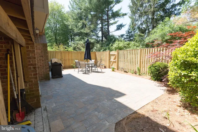 a view of a patio with table and chairs and potted plants