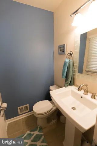 a bathroom with a sink a toilet and mirror
