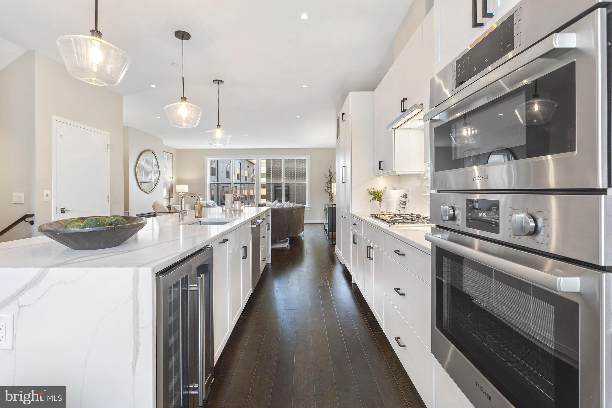 a large kitchen with a lot of counter space and stainless steel appliances