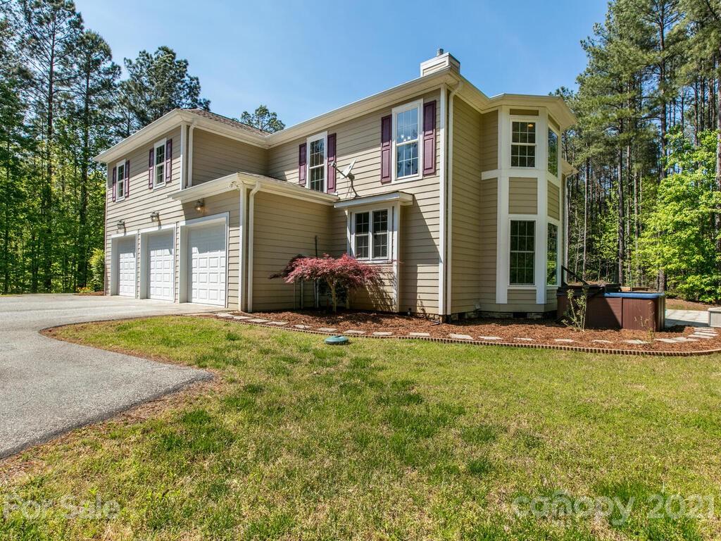 356 Green Hills Road Mill Spring, NC 28756 - Photo 2 of 31 a front view of a house with a yard and garage