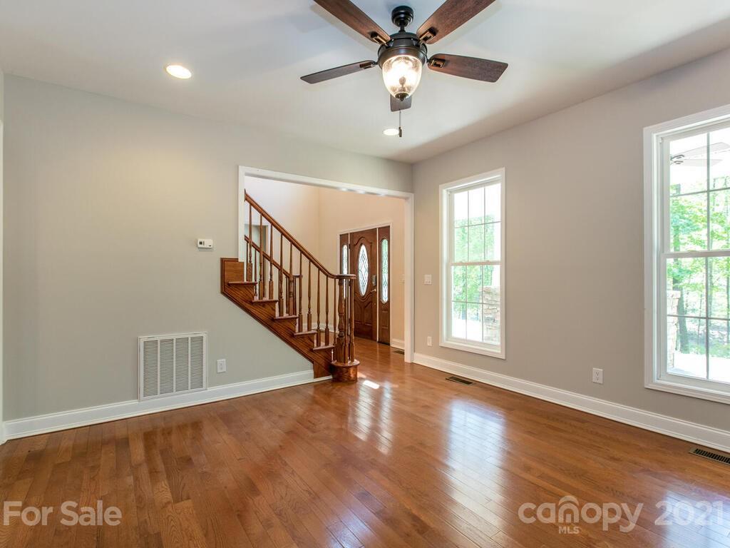 356 Green Hills Road Mill Spring, NC 28756 - Photo 14 of 31 an entryway in a hall with a window and wooden floor