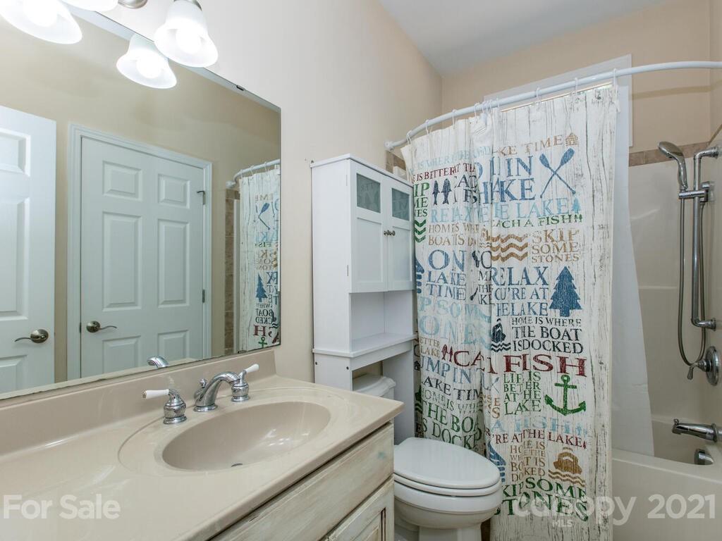 356 Green Hills Road Mill Spring, NC 28756 - Photo 15 of 31 a bathroom with a sink toilet and shower