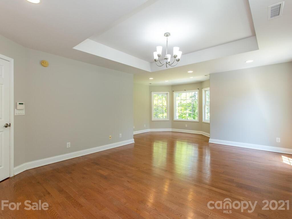 356 Green Hills Road Mill Spring, NC 28756 - Photo 16 of 31 wooden floor in an empty room with a window