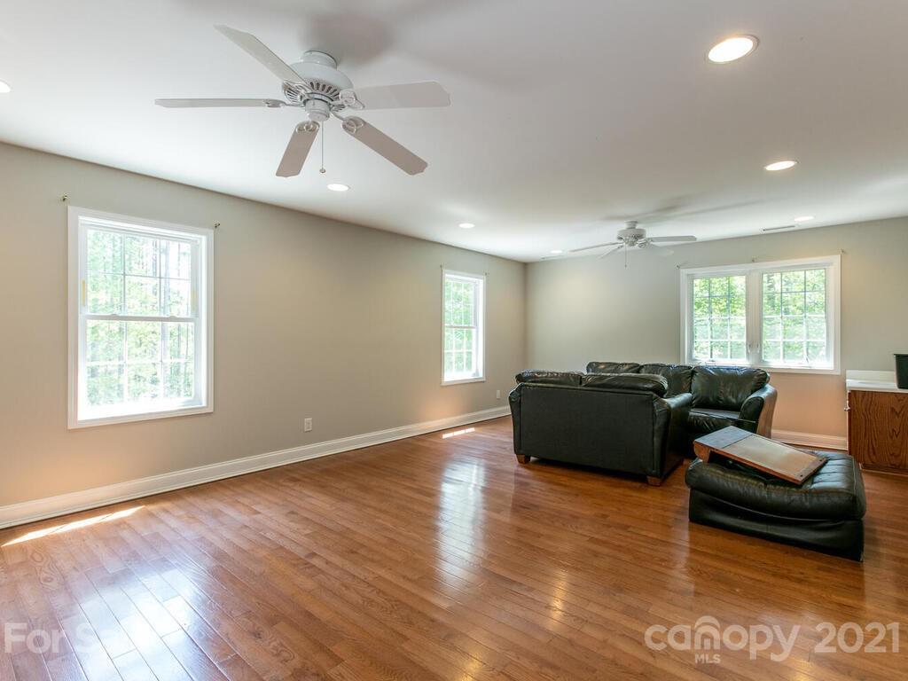356 Green Hills Road Mill Spring, NC 28756 - Photo 22 of 31 a living room with furniture and a large window