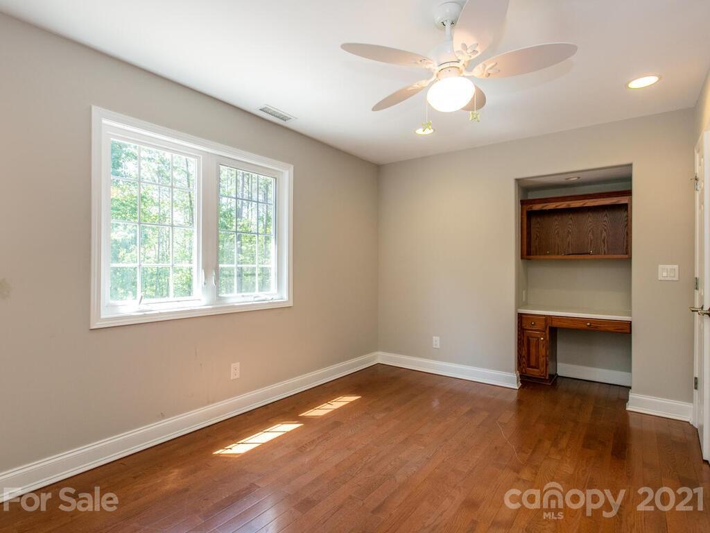 356 Green Hills Road Mill Spring, NC 28756 - Photo 23 of 31 wooden floor in an empty room with a window