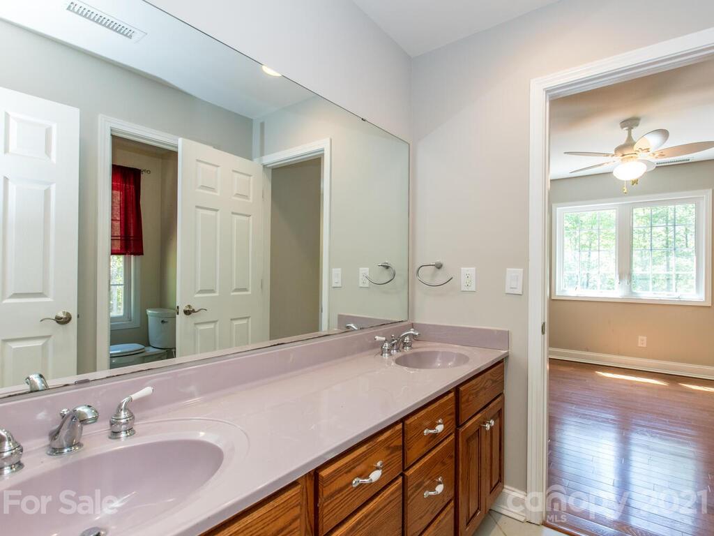 356 Green Hills Road Mill Spring, NC 28756 - Photo 24 of 31 a bathroom with a sink double vanity and a mirror