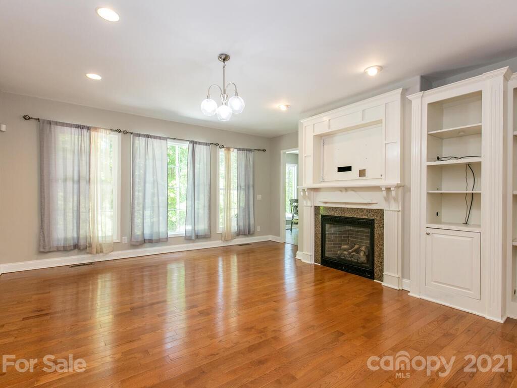 356 Green Hills Road Mill Spring, NC 28756 - Photo 7 of 31 a view of an empty room with a fireplace and a window