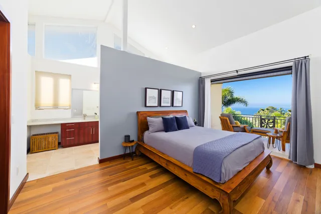 a bedroom with a bed and a dresser next to a window