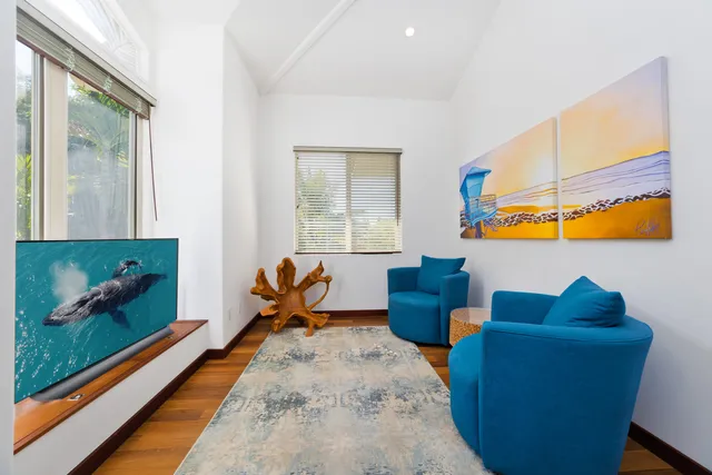 a living room with furniture and a floor to ceiling window