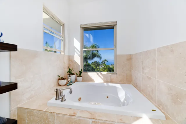 a bath tub sitting in a bathroom next to a white sink
