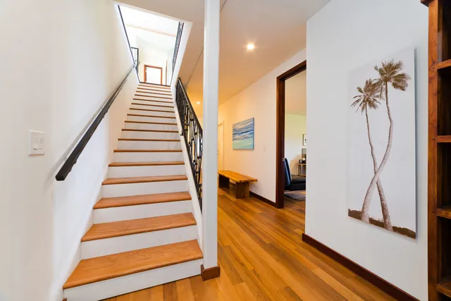 a view of entryway and hall with wooden floor