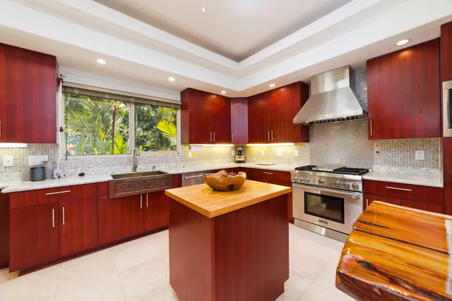 a kitchen with stainless steel appliances granite countertop a stove a sink dishwasher and a microwave oven with cabinets