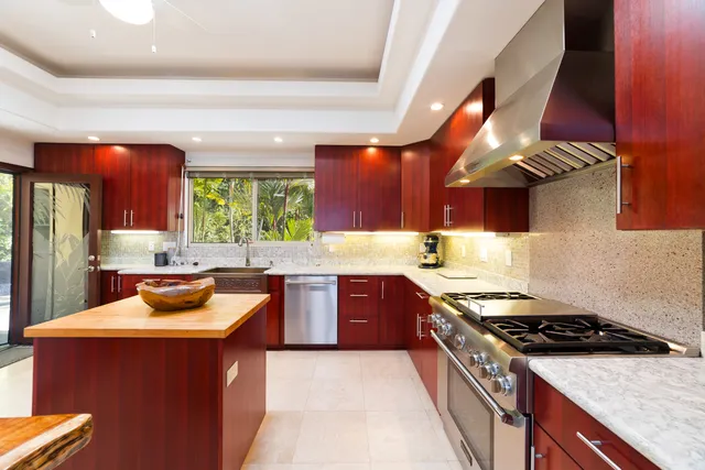 a kitchen with stainless steel appliances a stove a sink and a refrigerator