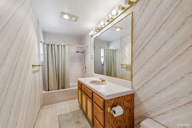 a bathroom with a sink a mirror and a shower