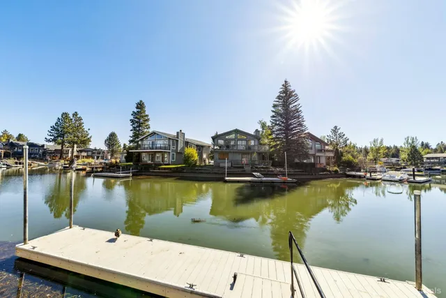 a view of a lake with boats and trees in the background
