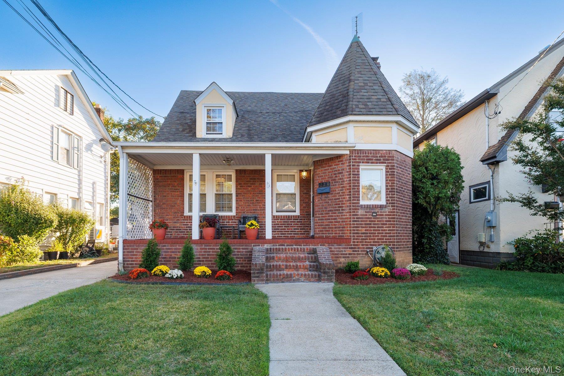 a front view of house with yard and outdoor seating