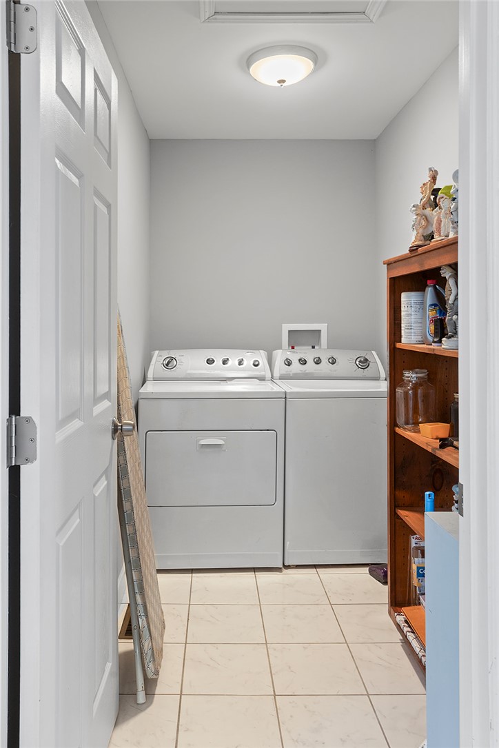 119 Nicholas Court Easley, SC 29640 - Photo 16 of 33 This dedicated laundry space combines efficiency with classic style, featuring durable tile flooring and essential appliances.