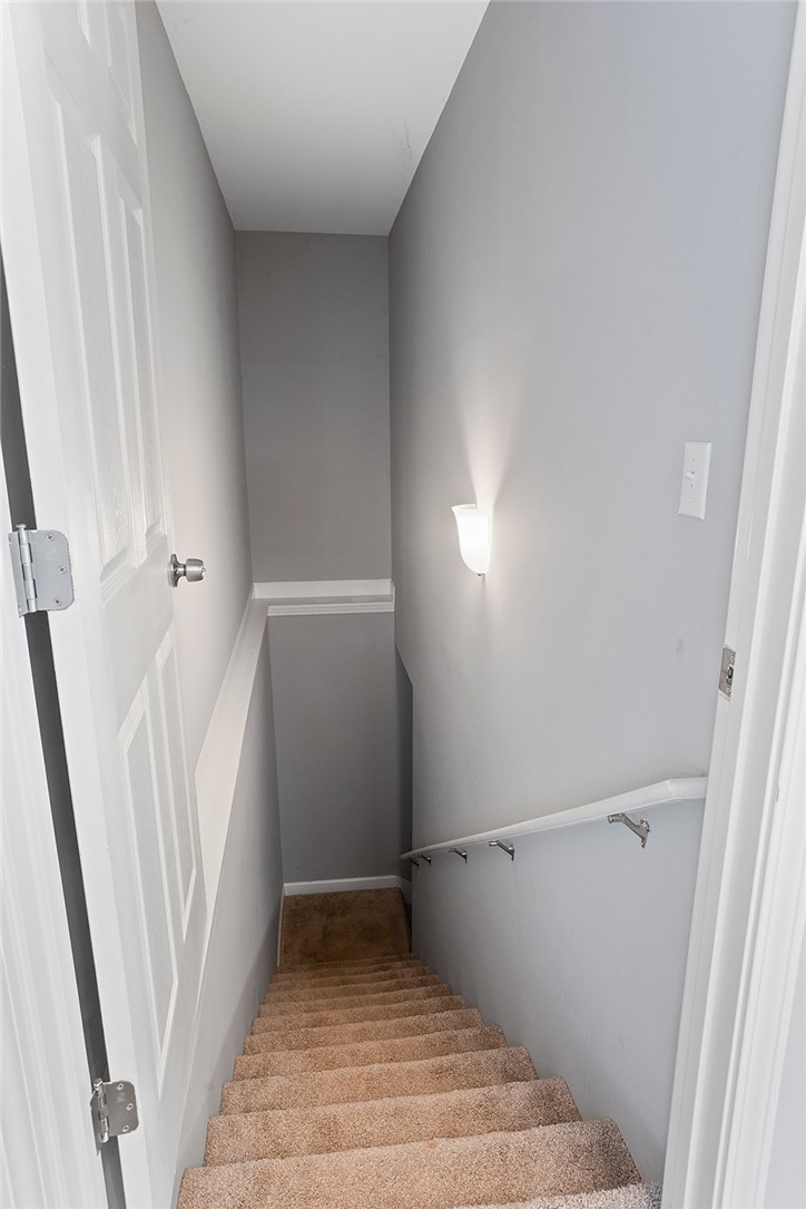119 Nicholas Court Easley, SC 29640 - Photo 25 of 33 Descend into additional living space down these well-lit, carpeted stairs.