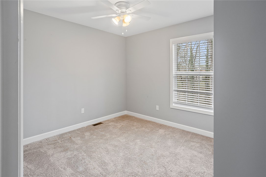 119 Nicholas Court Easley, SC 29640 - Photo 7 of 33 This spacious room features a ceiling fan, plush carpeting, and abundant natural light.