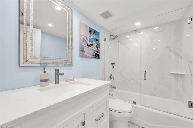 a bedroom with a large bed and a large window