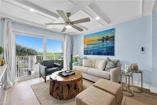 a living room with furniture tv and a large window
