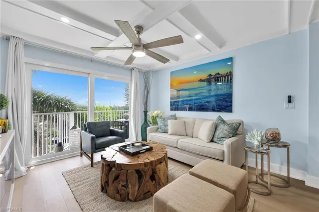 a living room with furniture tv and a large window