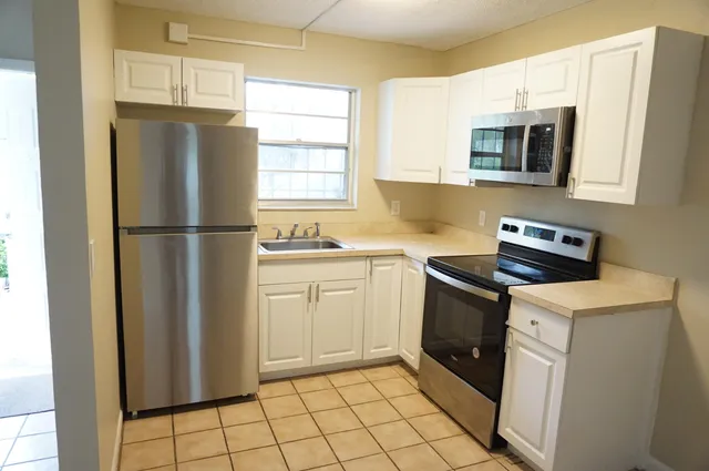 a kitchen with a refrigerator sink and microwave
