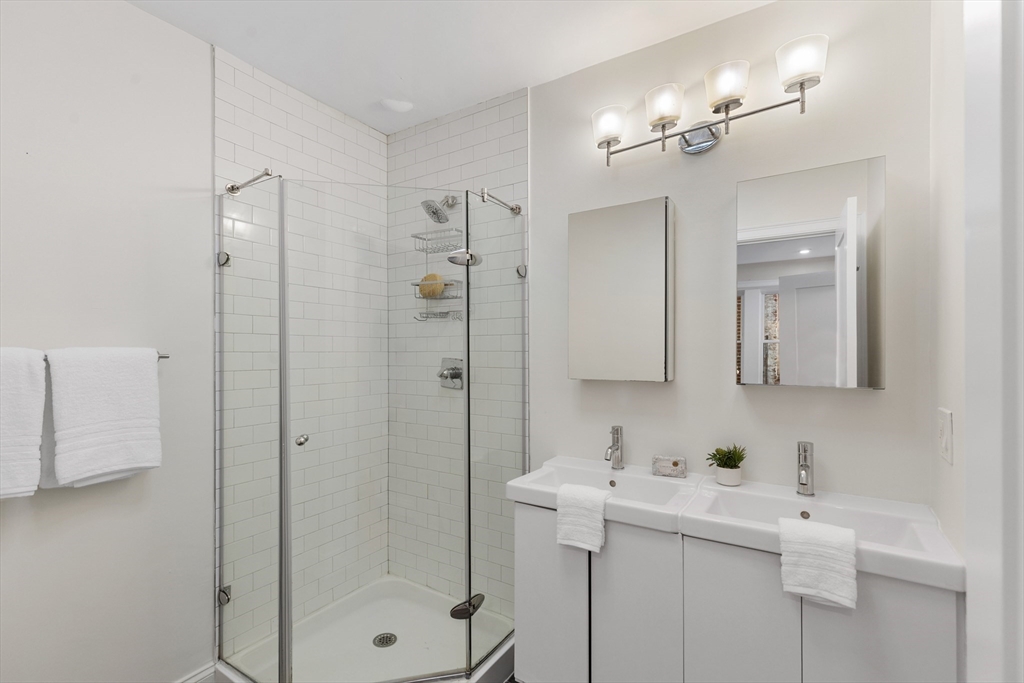 81 Prince Street, Unit 2 Boston, MA 02113 - Photo 13 of 22 a bathroom with a sink a mirror a vanity and shower