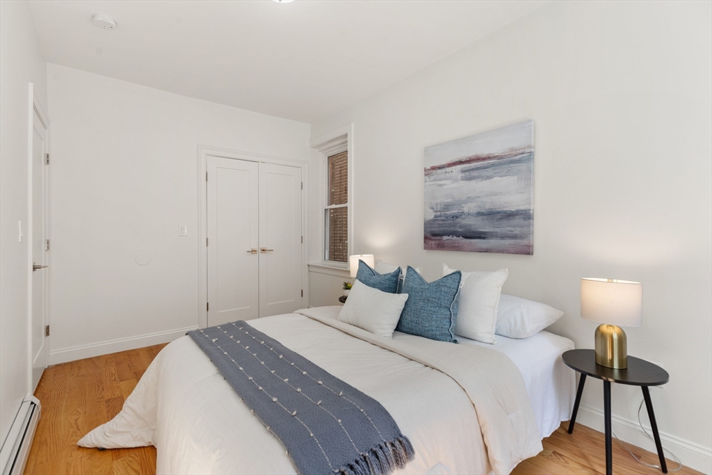 81 Prince Street, Unit 2 Boston, MA 02113 - Photo 18 of 22 a bedroom with a bed and a painting on the wall
