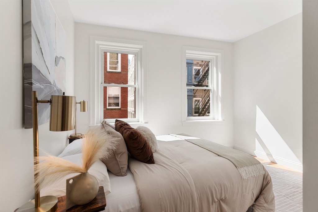 81 Prince Street, Unit 2 Boston, MA 02113 - Photo 19 of 22 a bedroom with a bed and glass windows