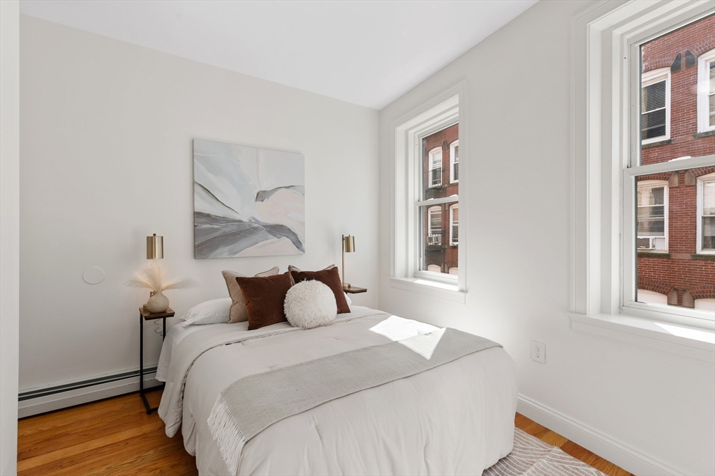 81 Prince Street, Unit 2 Boston, MA 02113 - Photo 20 of 22 a bedroom with a large bed and wooden floor