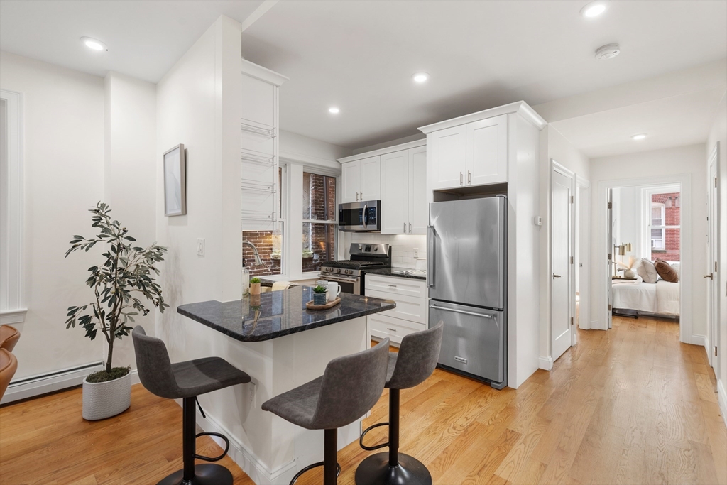 81 Prince Street, Unit 2 Boston, MA 02113 - Photo 7 of 22 a kitchen with stainless steel appliances a refrigerator and a stove top oven