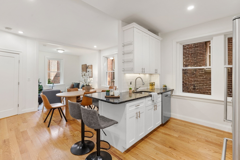 81 Prince Street, Unit 2 Boston, MA 02113 - Photo 8 of 22 a kitchen with stainless steel appliances granite countertop a stove and a wooden floors