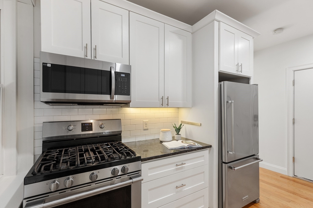 81 Prince Street, Unit 2 Boston, MA 02113 - Photo 10 of 22 a kitchen with stainless steel appliances granite countertop a stove and a refrigerator