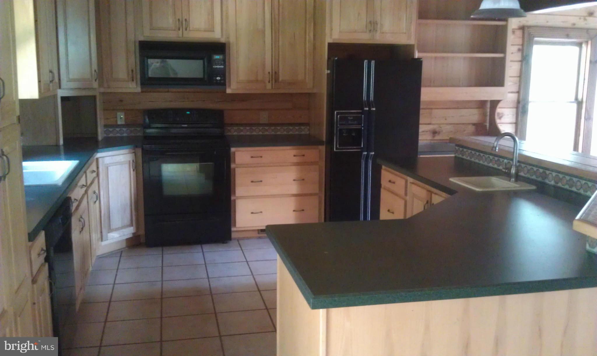 10471 Warland Road Marshall, VA 20115 - Photo 6 of 18 a kitchen with granite countertop a refrigerator and a stove