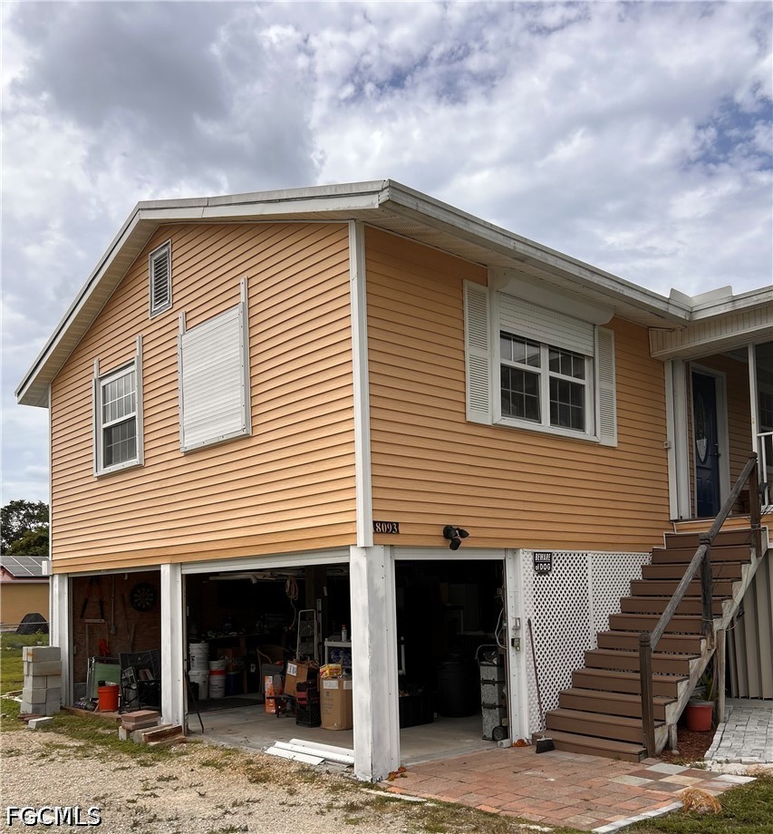 8093 Anhinga Road Fort Myers, FL 33967 - Photo 6 of 49 a front view of a house with stairs