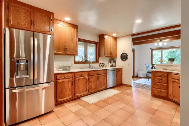 a kitchen with stainless steel appliances a refrigerator sink and cabinets