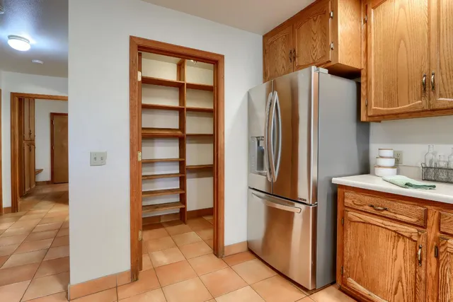 a kitchen with stainless steel appliances granite countertop a refrigerator and a sink