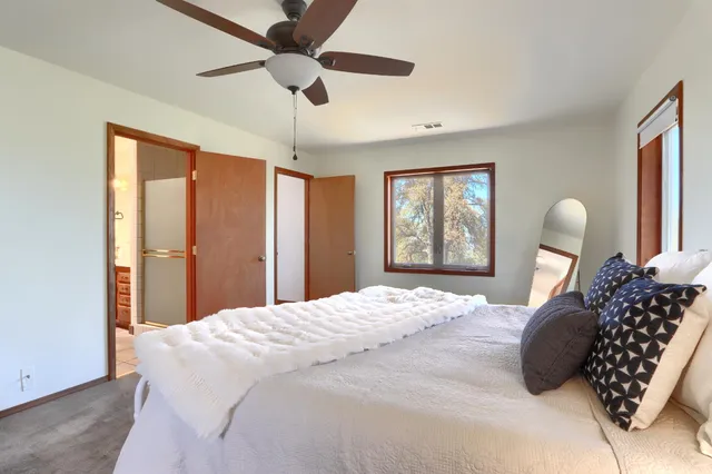 a bedroom with a large bed and a window