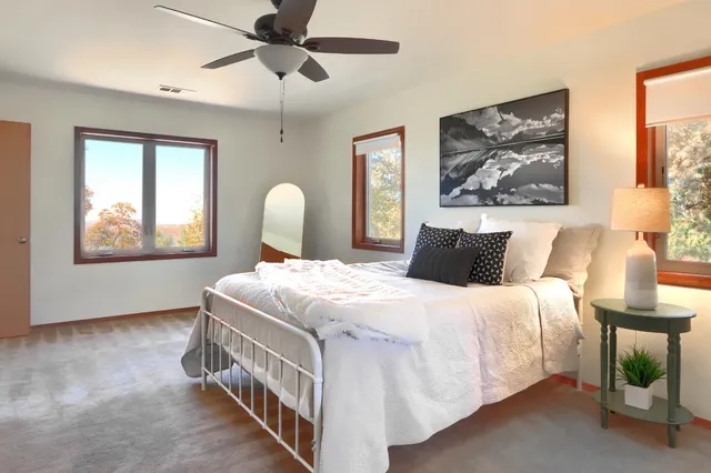 a bedroom with a bed and a painting on the wall