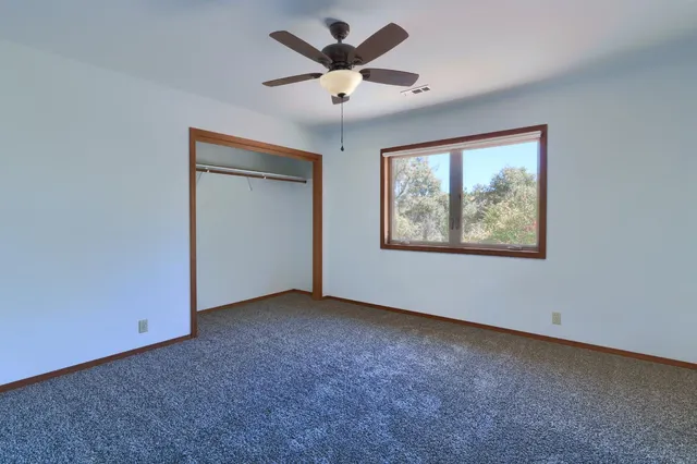 a bathroom with a granite countertop sink mirror and toilet